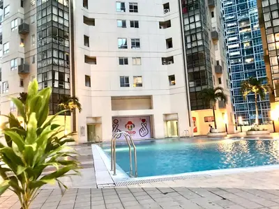 a swimming pool in a building with tall buildings at MaxStays - Max Home at Fort Victoria Tower A in Manila