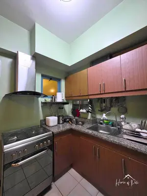 a kitchen with a stove and a sink at Home of Poli - 1BR with FREE Netflix & WiFi in Manila