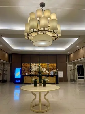 a large lobby with a table and a chandelier at Cozy Place at Shell Residences in Manila