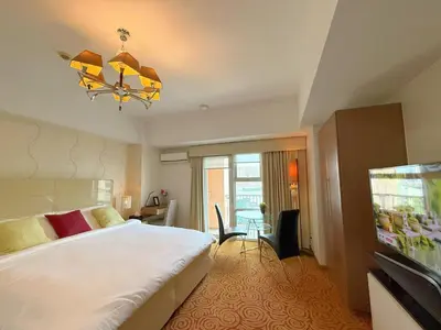 a hotel room with a large bed and a television at MaxStays - Max Home at The Venice Residences in Manila