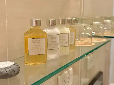 a group of four bottles of alcohol on a counter at MaxStays - Max Home at The Venice Residences in Manila