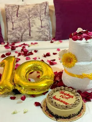 a table topped with a cake and a gold at MaxStays - Max Home at The Venice Residences in Manila