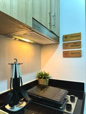 a kitchen with a sink with a laptop on a counter at Philhaus Staycation 2025 in Manila