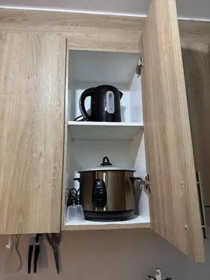 a tea pot sits inside of a kitchen cabinet at Philhaus Staycation 2025 in Manila