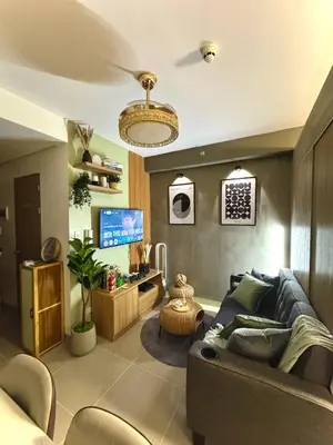 a living room with a couch and a tv at Philhaus Staycation 2025 in Manila