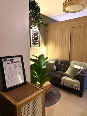 a living room with a couch and a table at Philhaus Staycation 2025 in Manila