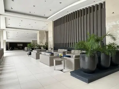 a lobby with couches and plants in a building at marbys pad shore residences in Manila