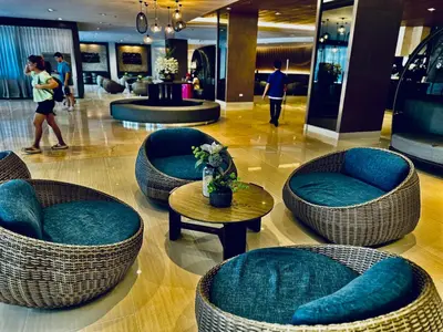 a lobby with chairs and tables in a mall at marbys pad shore residences in Manila