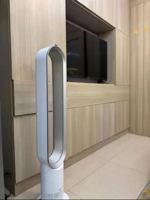 a room with a tv and a stand in front of a cabinet at marbys pad shore residences in Manila