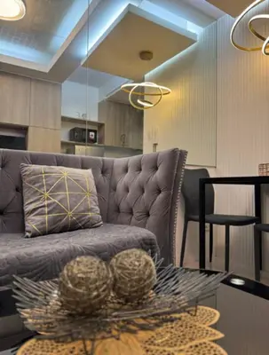 a living room with a couch and a table at marbys pad shore residences in Manila