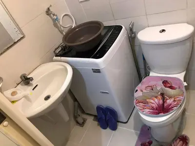 a bathroom with a grill and a toilet and a sink at 5 minutes to Jazz Mall Studio-type condo100mbps in Manila
