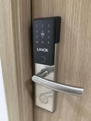 a close up of a door with a locking handle at staycation condo one bedroom balcony w pool view near SMX SM MOA IKEA NAIA DFA OCEAN PARK in Manila