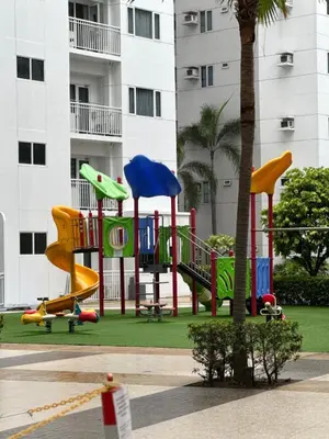 a playground in front of a building at staycation condo one bedroom balcony w pool view near SMX SM MOA IKEA NAIA DFA OCEAN PARK in Manila