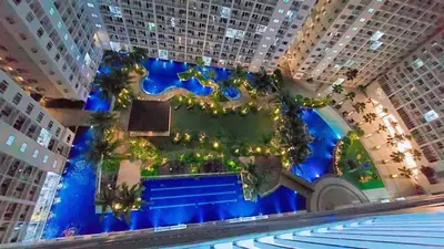 an aerial view of a large building with a pool at STAYCATION CONDO SHORE RESIDENCES one bedroom w balcony pool view near SMX SM MOA IKEA NAIA DFA OCEAN PARK DFA in Manila