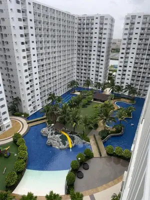 an aerial view of a resort with tall buildings at STAYCATION CONDO SHORE RESIDENCES one bedroom w balcony pool view near SMX SM MOA IKEA NAIA DFA OCEAN PARK DFA in Manila