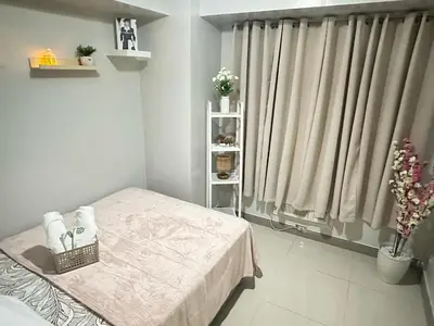 a small bedroom with a bed and a window at Les Chambres Cosy - Sea Residences MOA PASAY in Manila