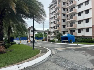 an empty street in front of a building at Functional stay near airport, business districts in Manila
