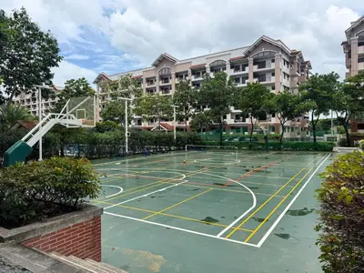 an empty basketball court in front of a building at Functional stay near airport, business districts in Manila