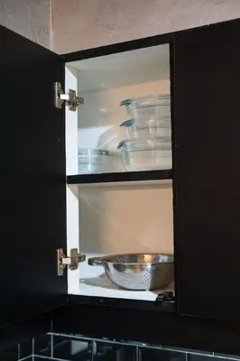 a cabinet with a bowl and dishes in it at Functional stay near airport, business districts in Manila