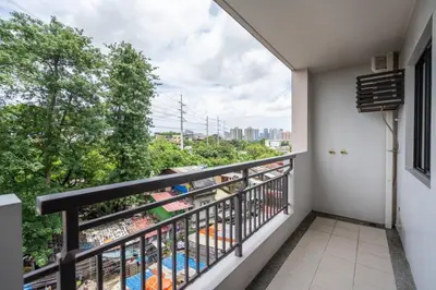 a balcony with a view of a city at Functional stay near airport, business districts in Manila