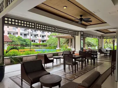 a restaurant with tables and chairs and a garden at Functional stay near airport, business districts in Manila