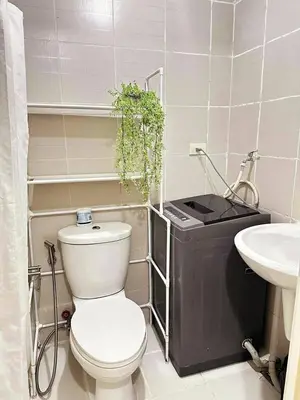 a bathroom with a toilet and a sink at Fourth's Jazz Cozy Pad in Manila