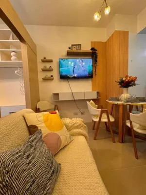 a living room with a couch and a tv at Fourth's Jazz Cozy Pad in Manila