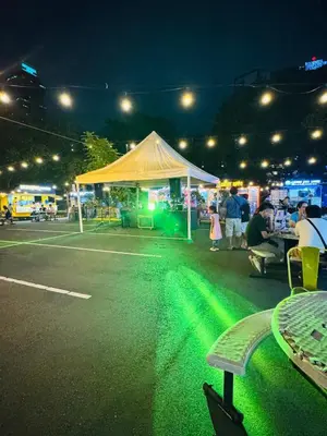 a white tent with green lights in a parking lot at KD's Home - Fast WiFi, Netflix , Pool , Karaoke in Manila