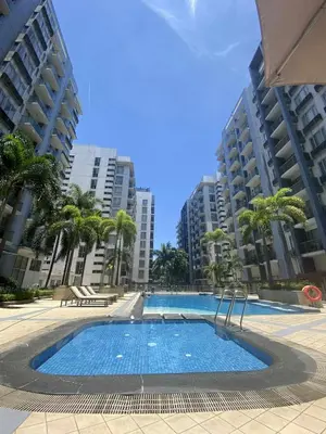 a large swimming pool with palm trees and buildings at Bekipay Suite at One Palm Tree right across NAIA 3 in Manila