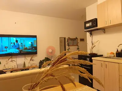 a living room with a flat screen tv on the wall at Gale Haven in Manila