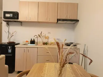 a kitchen with a table with a vase on it at Gale Haven in Manila