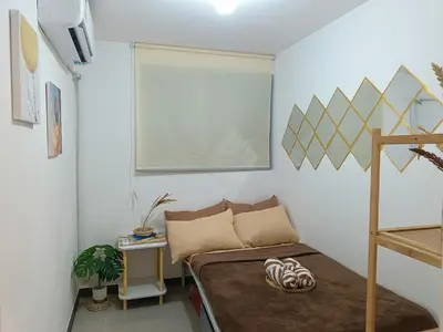 a small room with a bed and a window at Gale Haven in Manila