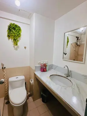 a bathroom with a toilet and a sink at Stan Condo in Manila