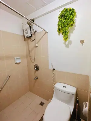 a bathroom with a toilet and a shower at Stan Condo in Manila
