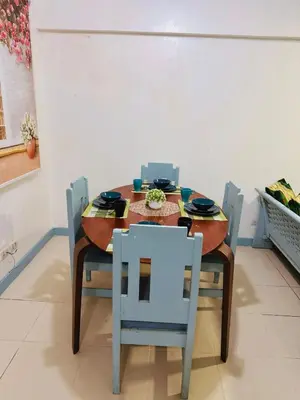a dining room table and chairs in a room at Stan Condo in Manila