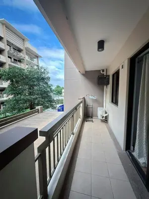 a balcony with a view of a building at Stan Condo in Manila