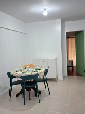 a dining room with a table and two chairs at Stan Condo in Manila