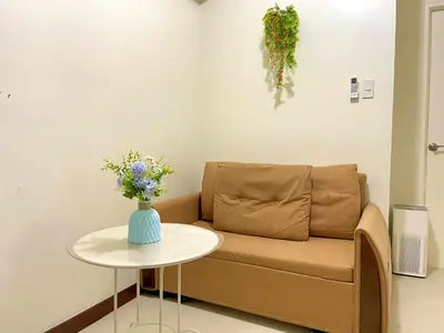 a living room with a couch and a table at Vtan Condo in Manila