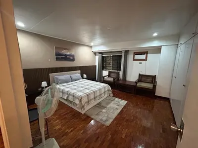 a small bedroom with a bed and a window at 4Br House in Pasay near airport in Manila