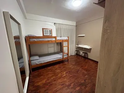 a room with two bunk beds and a mirror at 4Br House in Pasay near airport in Manila