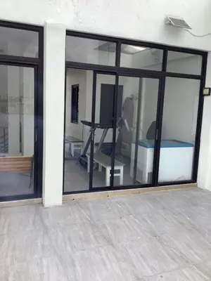 a room with large glass windows and a tv at Amp rental unit in Manila