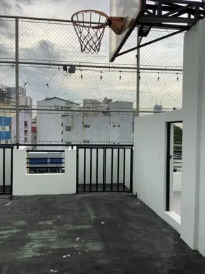 an empty basketball court with a hoop on a fence at Amp rental unit in Manila