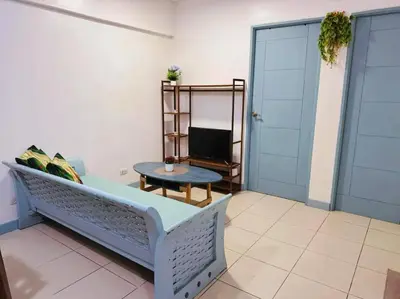 a living room with a couch and a table at Arista place staycation in Manila