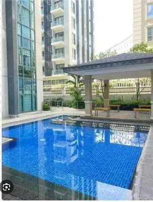 a large blue swimming pool in a building at MCV Condotel Near Terminal 3 in Manila