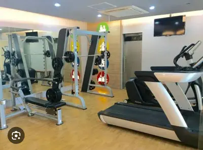 a gym with several tread machines in a room at MCV Condotel Near Terminal 3 in Manila