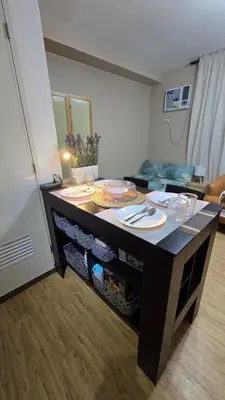 a kitchen with a table with food on it at Metrotowne PHINMA Las Pinas in Manila