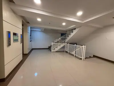 an empty hallway with stairs in a building at Metrotowne PHINMA Las Pinas in Manila