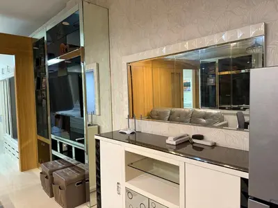 a living room with a couch and a large mirror at PinkdoorZ Moa Staycation at Shell Residences in Manila