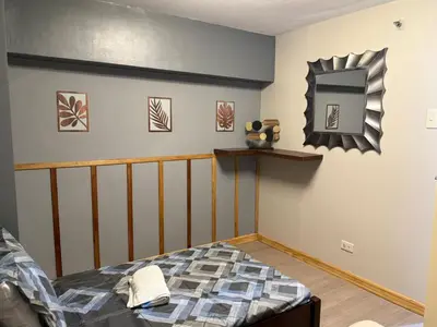 a bedroom with a bed and a mirror on the wall at California Gardens square in Manila