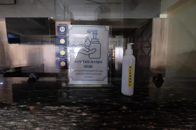 a bottle of soap and a sign in a bathroom at Oriental Zen Suites in Manila